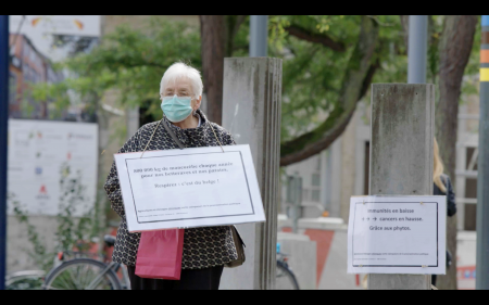 La protagoniste du film tient une pancarte contre les pesticide